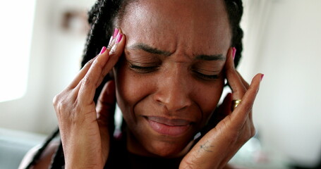 Frustrated black woman feeling stress. African ethnicity person close-up[ face headache