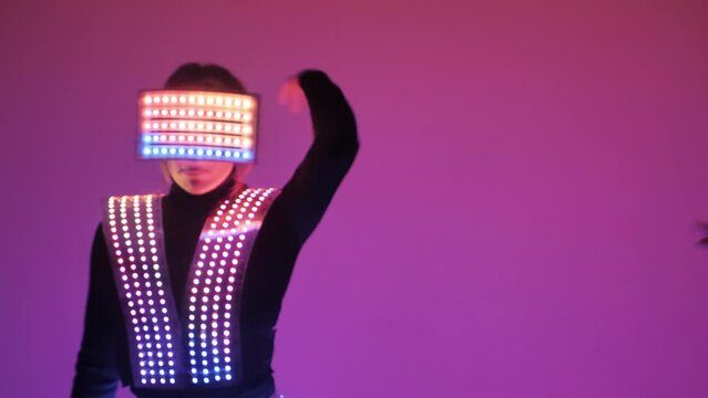 Two  disco dancers move in UV costumes.