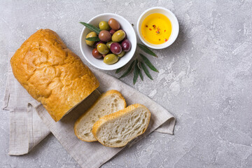 Bowl of delicious olives with oil and bread