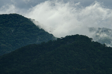 Mountain range from the sea in a summer day. Photo zoom.