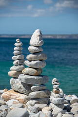 Pile of stones on a beach, ocean background in Brittany, France