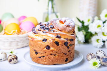 Craffin (Cruffin) with raisins and candied fruits. Easter Bread Kulich and painted eggs. Easter Holiday. Close-up.