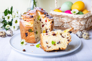 Craffin (Cruffin) with raisins and candied fruits. Easter Bread Kulich and painted eggs. Easter Holiday. Close-up.