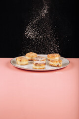 delicious homemade syrniki with honey on a black background