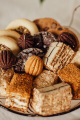 cookies and sweets on a stand, a piece of cake