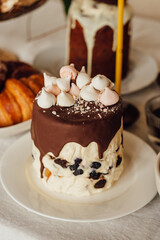 Traditional Ukrainian Easter cake. Traditional dessert. Easter cake stands on a festive table decorated with sweets. Holy Easter