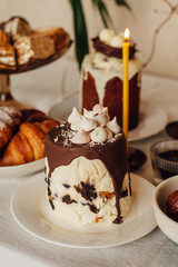 Traditional Ukrainian Easter cake. Traditional dessert. Easter cake stands on a festive table decorated with sweets. Holy Easter