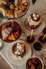 Traditional Ukrainian Easter cake. Traditional dessert. Easter cake stands on a festive table decorated with sweets. Holy Easter
