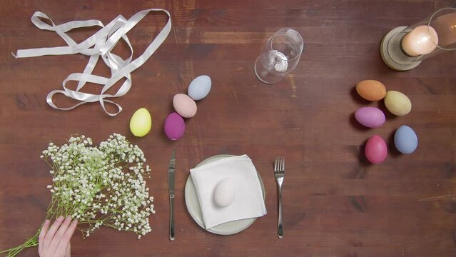 Top view of a table with items to create a composition for Easter. Women's hands arrange objects on the table. Church holiday-Easter