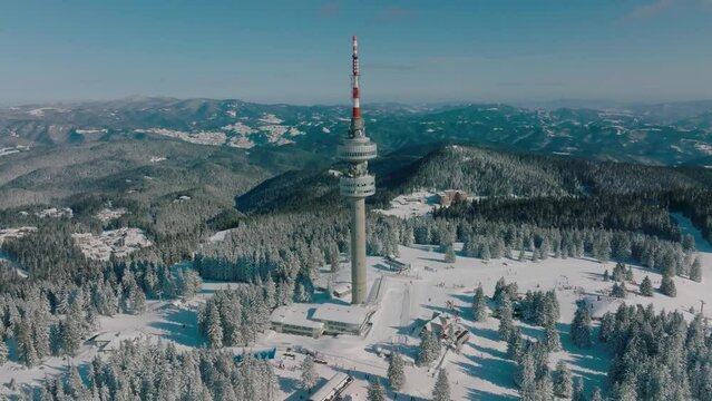4K Aerial winter view of Rhodope Mountains and Snezhanka tower near resort of Pamporovo, Smolyan Region, Bulgaria