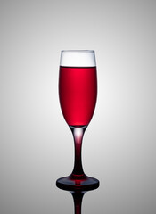 a glass of red wine on a gray gradient background, alcoholic beverage 