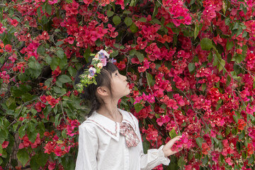 A little girl enjoying flowers in spring