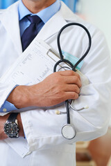 The first line in diagnosis. Closeup shot of a doctor holding a patient chart and a stethoscope.