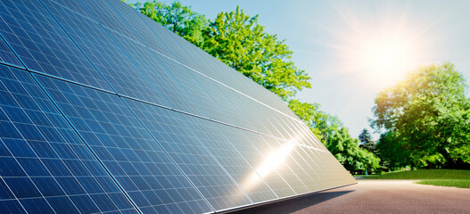 Solar power plant at sunrise with green environment
