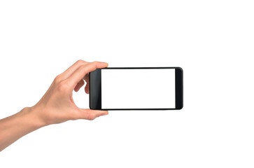 Black smartphone in a female hand on a white background, isolate. Smartphone with blank white display for advertising.