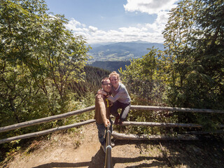 Fototapeta na wymiar A lovely couple enjoying time together outdoors in the mountains on a bright sunny day