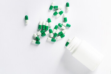 Assorted pharmaceutical medicine pills, tablets and capsules and bottle on white background. Top view. Flat lay. Copy space. Medicine concept. Heap of pills on white background