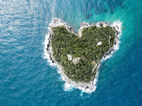 Aerial view of Bergeggi island, heart island from above, in Liguria, north Italy. Drone photography of the Ligurian coast, province of Savona with Spotorno and the island of Bergeggi.