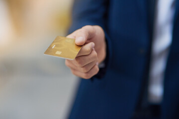 Paying by card. Cropped shot of an unrecognizable businessman holding out a credit card.