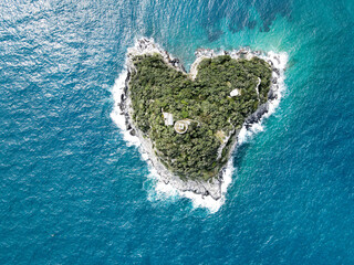 Aerial view of Bergeggi island, heart island from above, in Liguria, north Italy. Drone photography of the Ligurian coast, province of Savona with Spotorno and the island of Bergeggi.