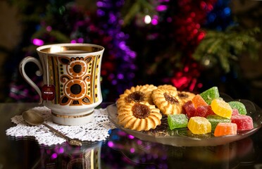 a cup of tea with cookies and sweets