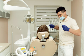 dental treatment process. the dentist holds the tools in his hands and examines the teeth. patient at the dentist. dental office.
