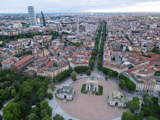 Fototapeta premium Aerial view of Arco della Pace in Milano, north Italy. Drone photography of Arch of Peace in Piazza Sempione, near Sempione park in the heart of Milan, Lombardy and Sforza Castle.
