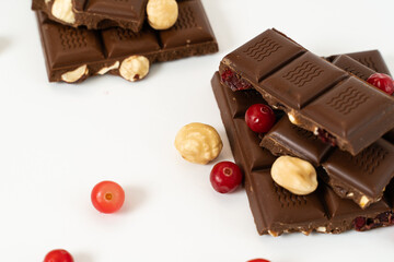 Heap of broken pieces of chocolate on white background