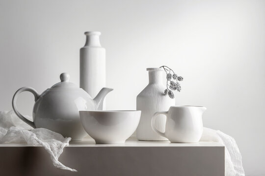 White still life with white dishes on a white background