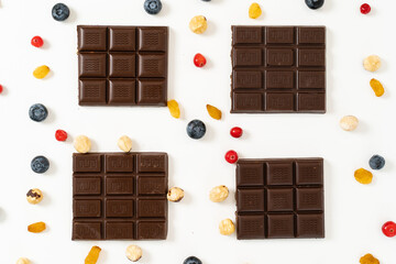 Heap of broken pieces of chocolate on white background