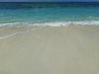 Fototapeta na wymiar Maldives, tropical paradise. A beach with the white sand near the turquoise ocean.