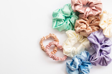 Collection of trendy silk elastic bands scrunchies on white background. Diy accessories and...