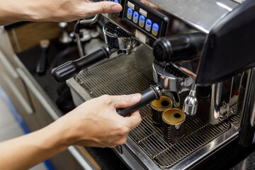 Barista make black coffee with coffee machine in cafe