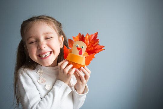 paper craft for kids. DIY Turkey made from pumpkin for thanksgiving day. create art for children. girl playing with toy