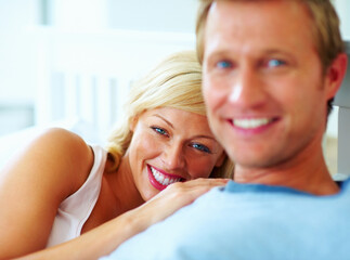 Happy middle aged woman resting on mans chest. Portrait of a happy middle aged woman resting on mans chest.