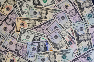 Banknotes of US dollars of different denominations arranged in random order
