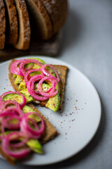Obraz na płótnie Canvas Red Onion Pickles Bread with Avocado