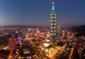 Fototapeta na wymiar Aerial skyline of Downtown Taipei at dusk, vibrant capital city of Taiwan, with 101 Tower standing out amid skyscrapers in Xinyi Commercial District and oval shaped Taipei Dome located in nearby area