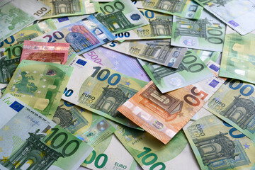 Obraz na płótnie Canvas Euro banknotes of different denominations arranged in random order