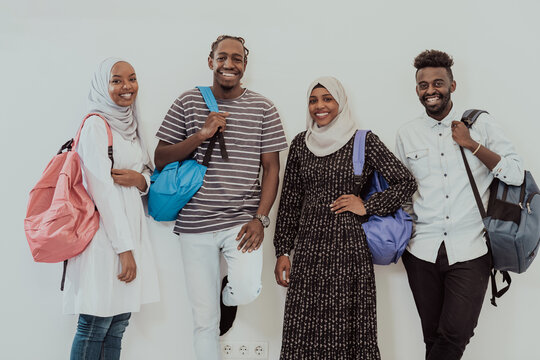 Photo of a group of happy african students talking and meeting together working on homework girls wearing traditional Sudanese Muslim hijab