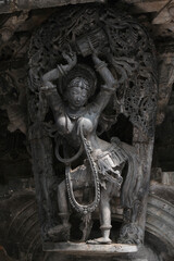 Stone Sculpture of Beautiful Female (Madanikas) with selective focus, 12th century Hindu temple, Ancient stone art and sculptures in each pillars, Chennakeshava Temple, Belur, Karnataka, India.