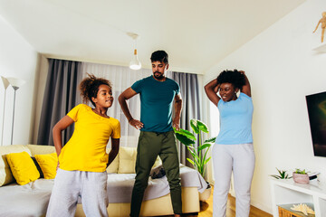 Naklejka premium Healthy morning stretching - family doing gymnastic exercise at home