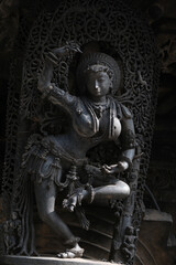 Stone Sculpture of Beautiful Female (Madanikas) with selective focus, 12th century Hindu temple, Ancient stone art and sculptures in each pillars, Chennakeshava Temple, Belur, Karnataka, India.