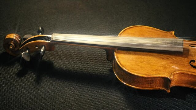 Slow pan across the honey body of a classic violin