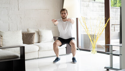 Portrait of man doing workout exercise indoors at home