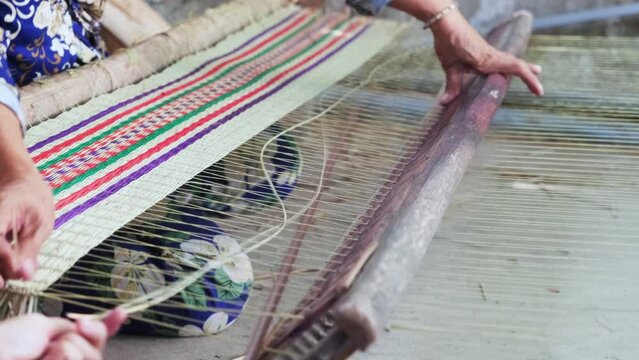 Close up of local asian woman making sedge mat organic Vietnamese product