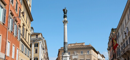Column of the Immaculate Conception against blue sky on a sunny day, Piazza Mignanelli, Rome, Italy