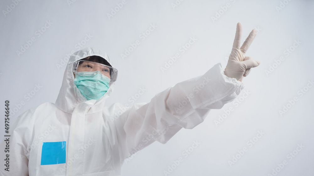 Wall mural doctor in ppe suit wearing white medical rubber gloves and clear goggles and green n95 face mask to 