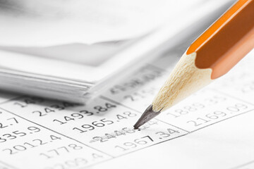 Accounting document with pencil and checking financial chart. Concept of banking, financial report and financial audit.