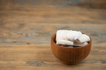 short pastry cookies in wood bowl, sprinkled with powdered sugar. ready-made shortbread.